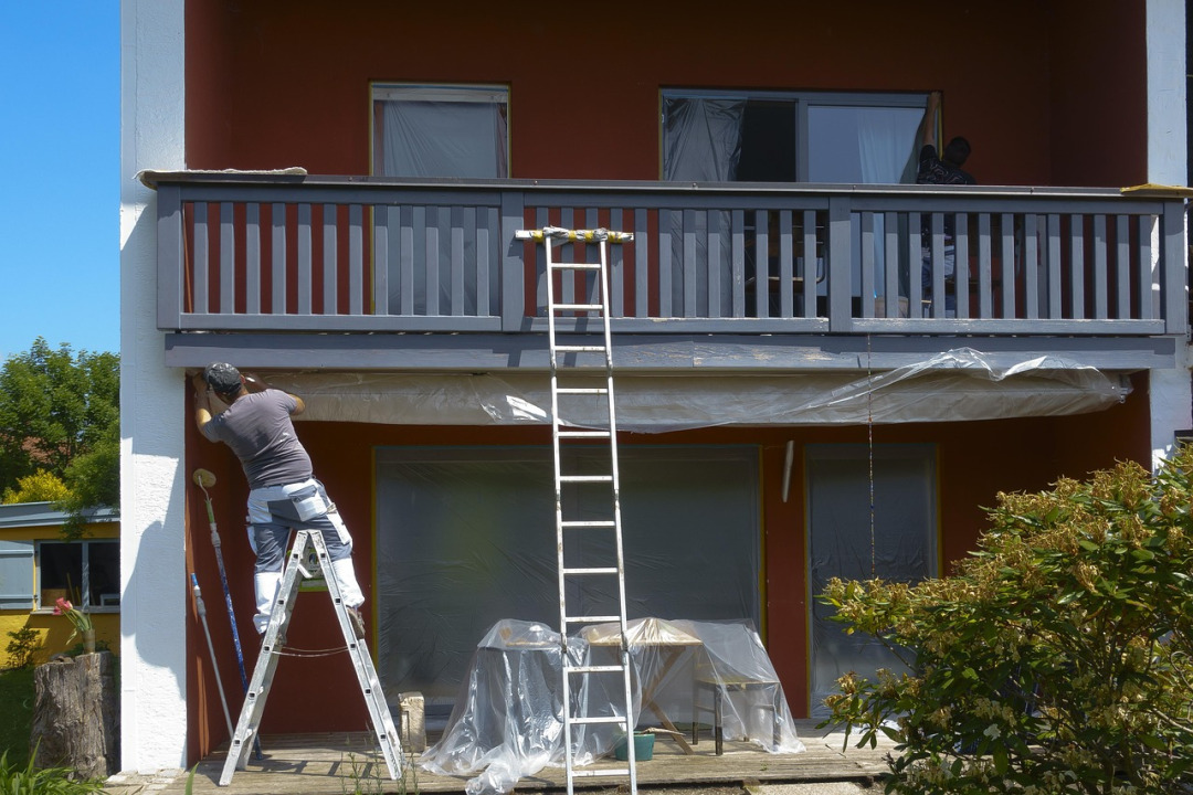 exterior painter on ladder
